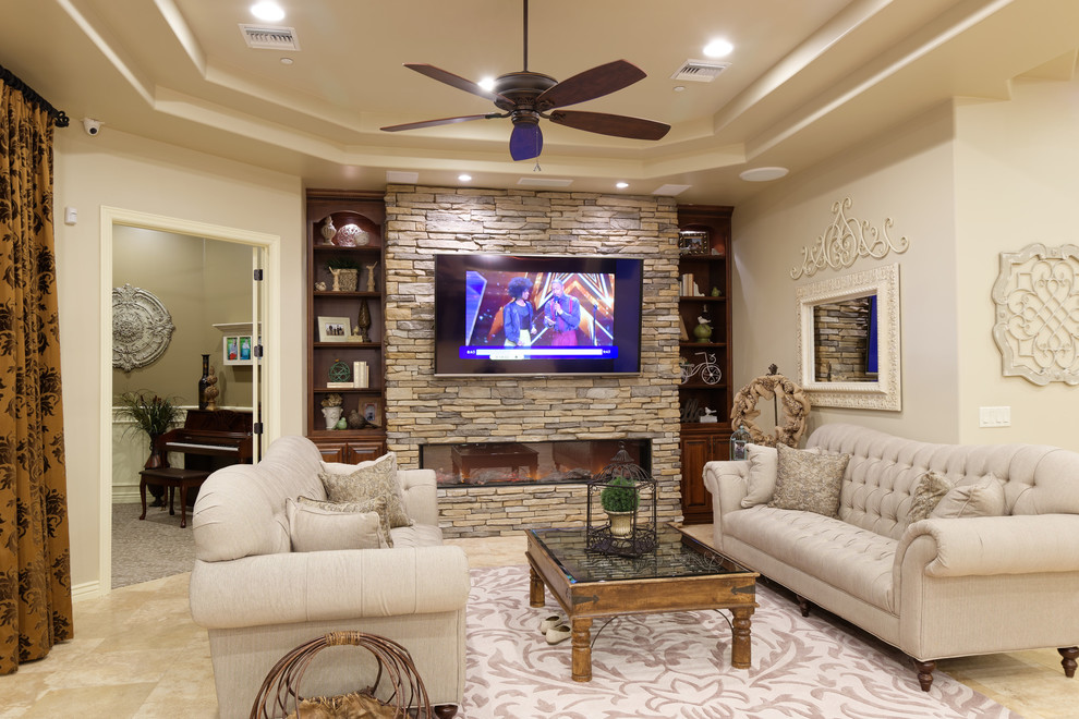 Mediterranean open concept living room in Phoenix with beige walls, travertine floors, a stone fireplace surround, a wall-mounted tv, a ribbon fireplace, beige floor and recessed.