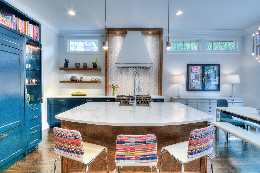 Inspiration for a transitional medium tone wood floor eat-in kitchen remodel in Austin with shaker cabinets, blue cabinets, multicolored backsplash, stainless steel appliances and an island