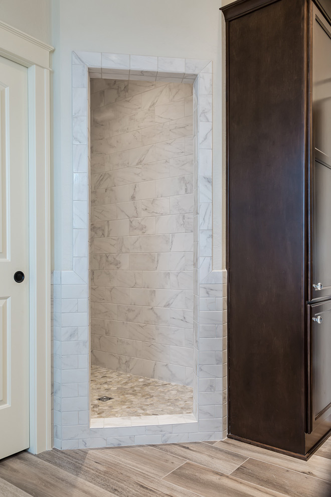 This is an example of a large traditional master bathroom in Other with an alcove shower, brown tile, porcelain tile, white walls, porcelain floors, recessed-panel cabinets, dark wood cabinets, a freestanding tub, a vessel sink, quartzite benchtops and brown floor.