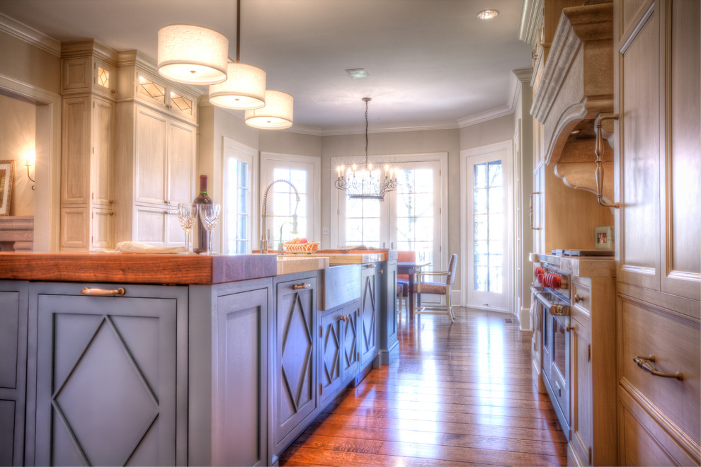 Eat-in kitchen - huge transitional eat-in kitchen idea in Indianapolis with a farmhouse sink, flat-panel cabinets, blue cabinets, white backsplash, paneled appliances and an island