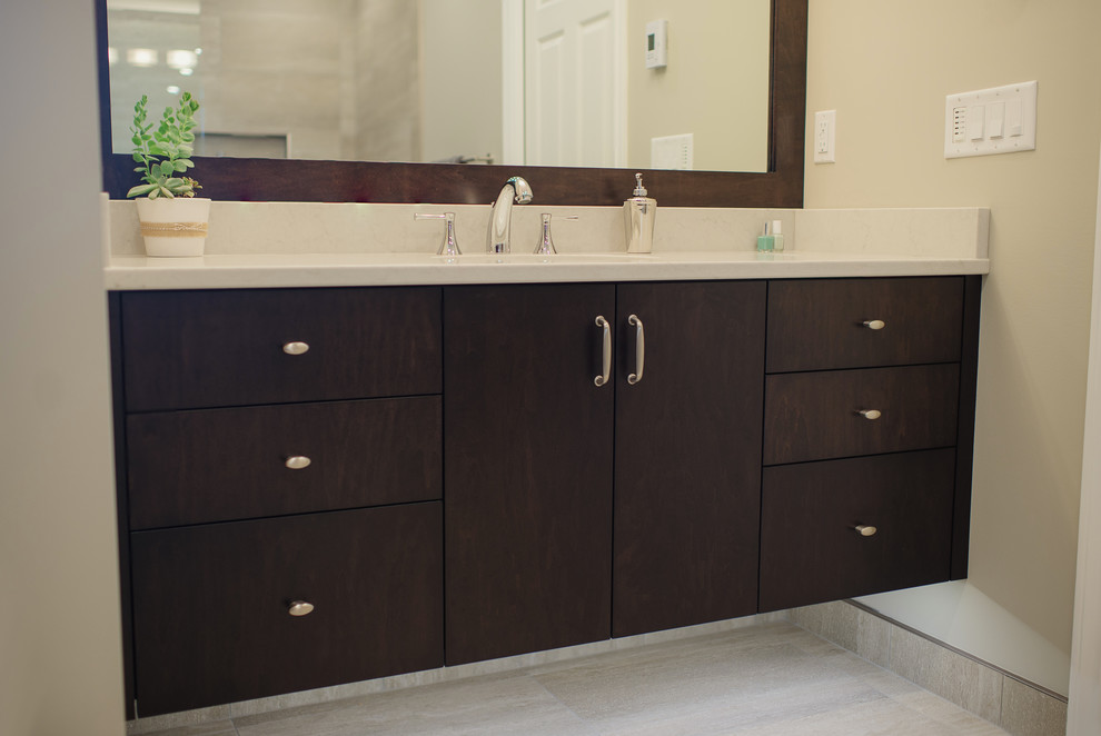 Inspiration for a mid-sized transitional bathroom in Vancouver with an undermount sink, flat-panel cabinets, dark wood cabinets, engineered quartz benchtops, a curbless shower, beige tile, porcelain tile, beige walls and porcelain floors.