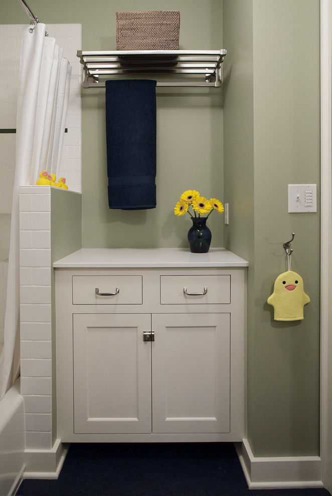 This is an example of a small arts and crafts kids bathroom in Portland with shaker cabinets, white cabinets, a drop-in tub, a shower/bathtub combo, white tile, subway tile, green walls, linoleum floors and engineered quartz benchtops.