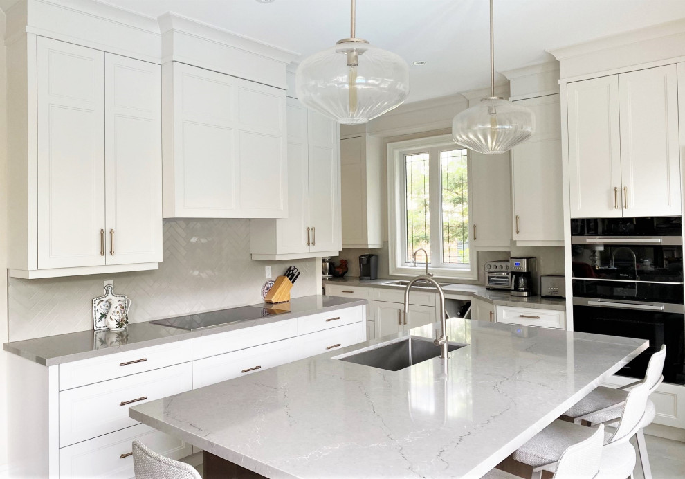 Example of a mid-sized transitional porcelain tile open concept kitchen design in Toronto with an undermount sink, recessed-panel cabinets, white cabinets, quartz countertops, gray backsplash, porcelain backsplash, stainless steel appliances, an island and gray countertops