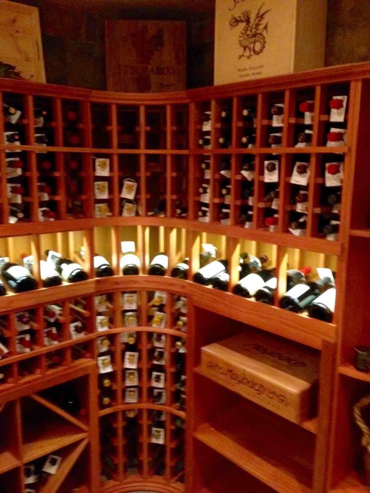Design ideas for a mid-sized traditional wine cellar in Dallas with storage racks.