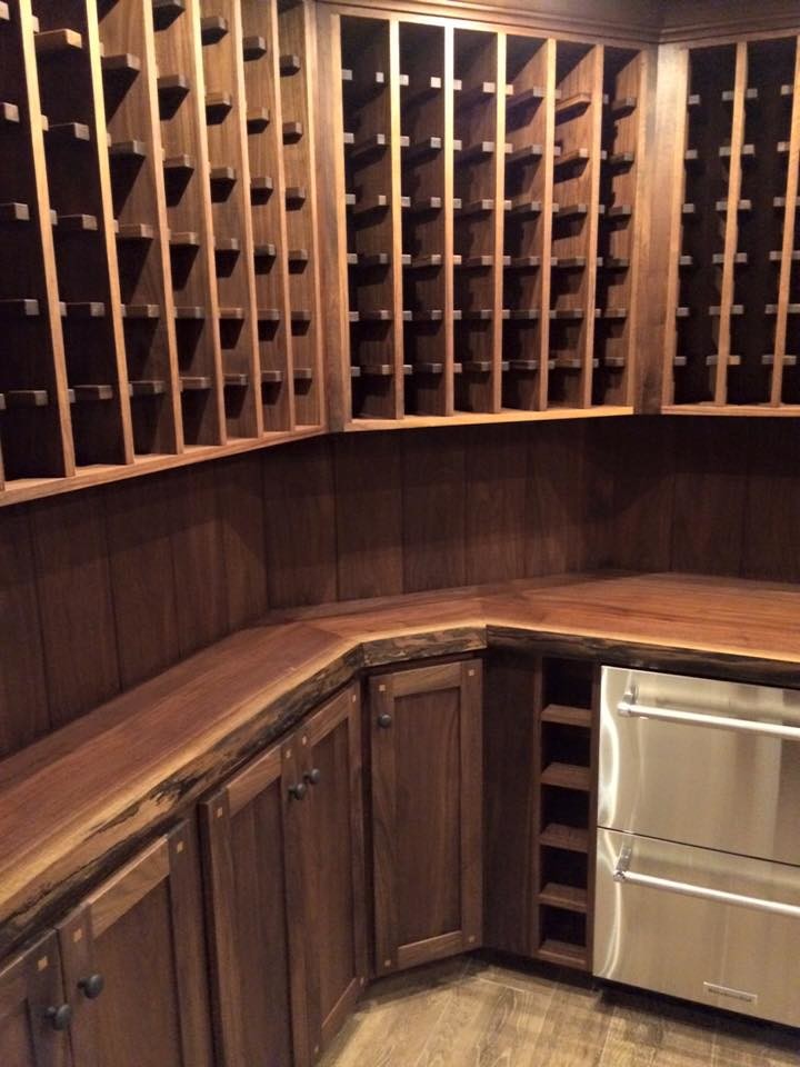 Inspiration for a large country wine cellar in Other with medium hardwood floors and storage racks.