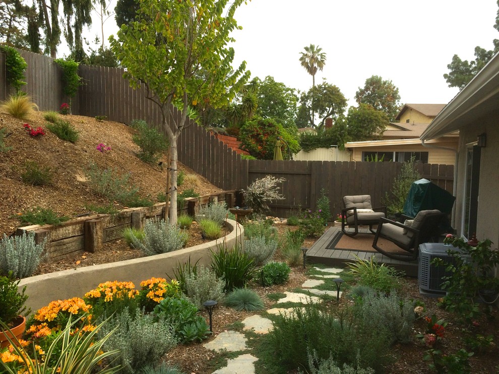 Mediterranean garden in San Diego with a retaining wall and decking.
