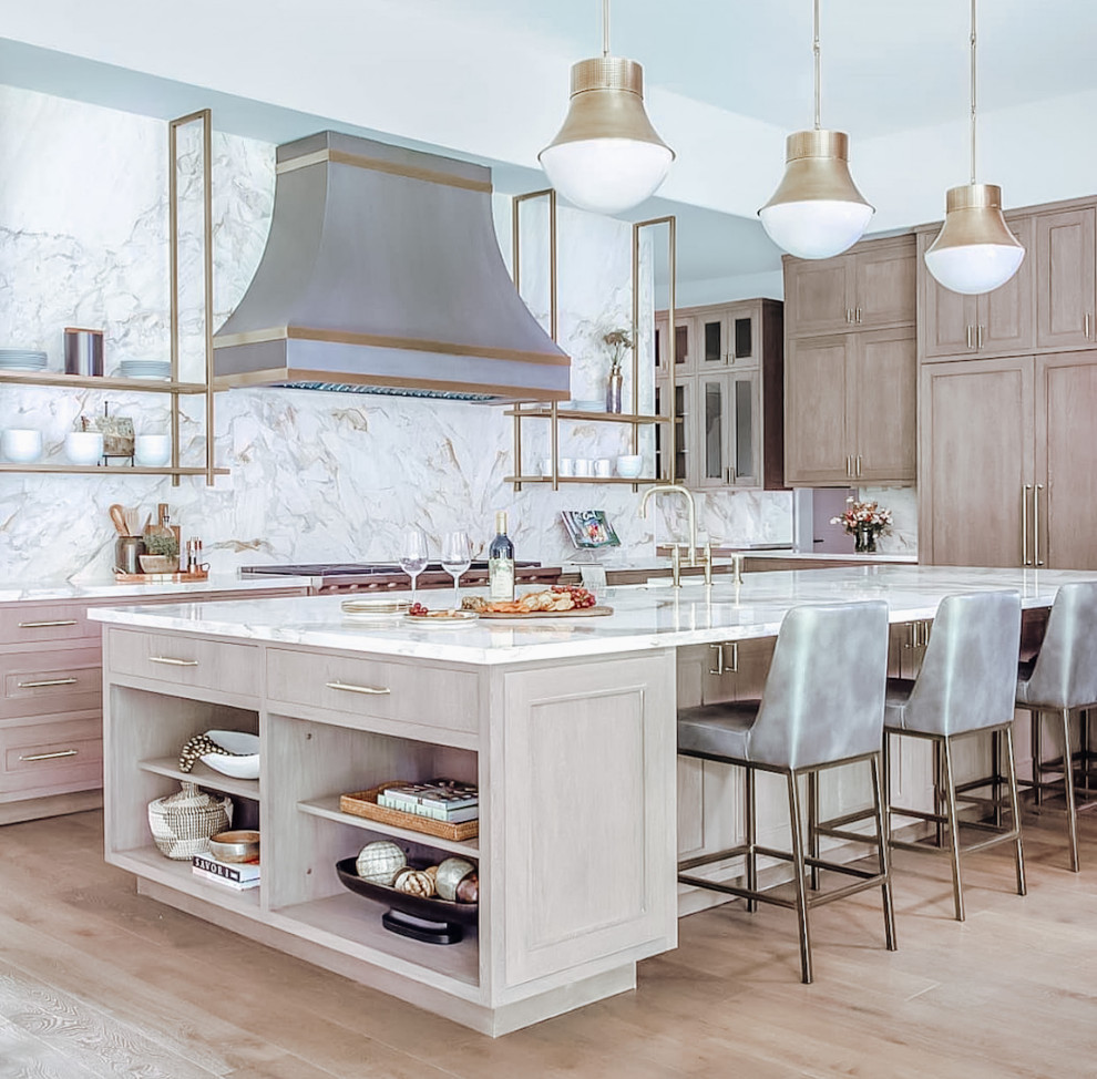 Photo of a large l-shaped eat-in kitchen in Dallas with marble benchtops, multi-coloured splashback, marble splashback, light hardwood floors, with island, vaulted, shaker cabinets, light wood cabinets, coloured appliances, white benchtop, an undermount sink and brown floor.