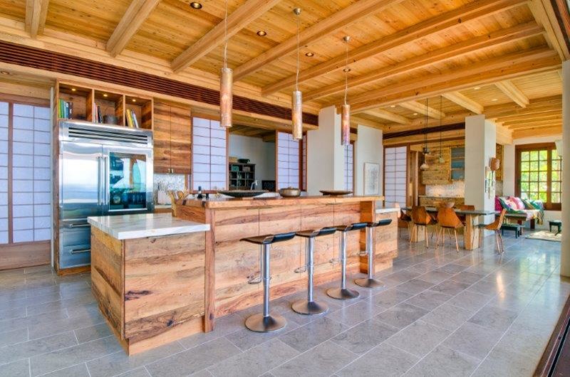Eat-in kitchen - mid-sized transitional galley porcelain tile eat-in kitchen idea in Austin with flat-panel cabinets, light wood cabinets, marble countertops, white backsplash, mosaic tile backsplash, stainless steel appliances and an island