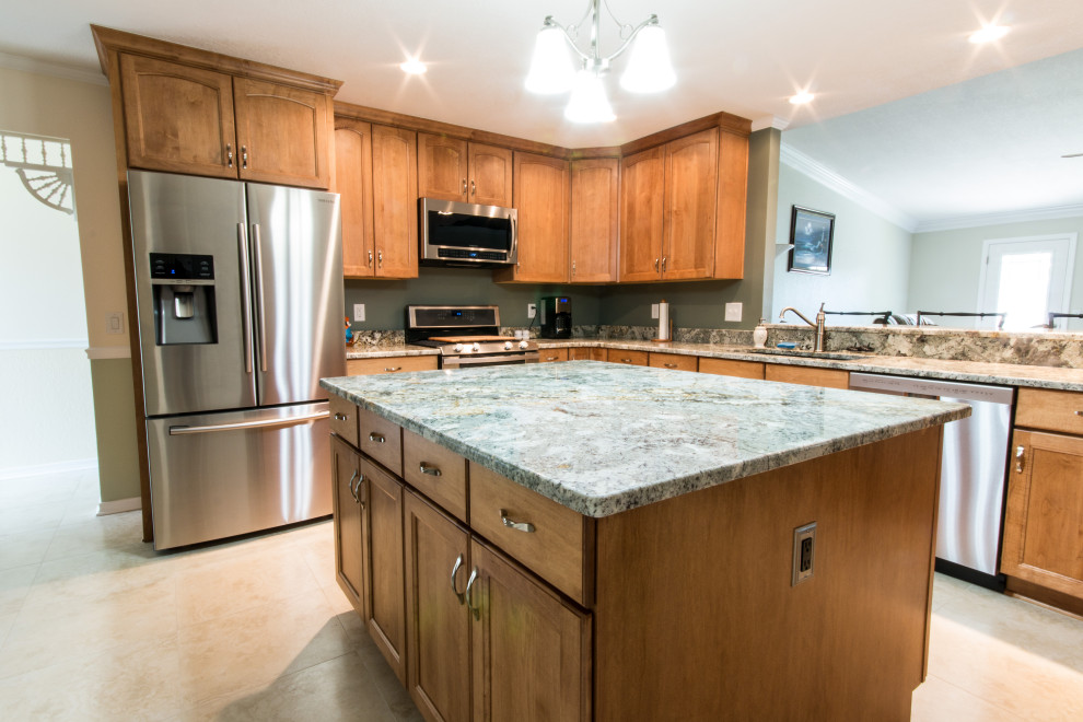 Example of a mid-sized l-shaped cement tile floor eat-in kitchen design with an undermount sink, flat-panel cabinets, medium tone wood cabinets, granite countertops, stainless steel appliances and an island