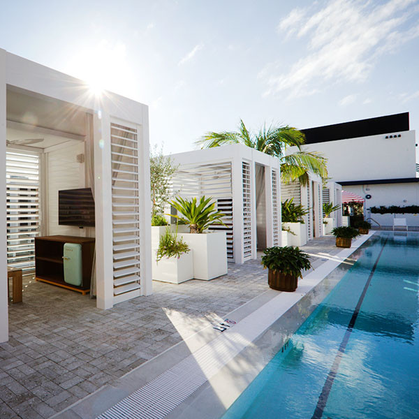 Design ideas for a small contemporary rooftop and rooftop deck in Miami with with privacy feature and a pergola.