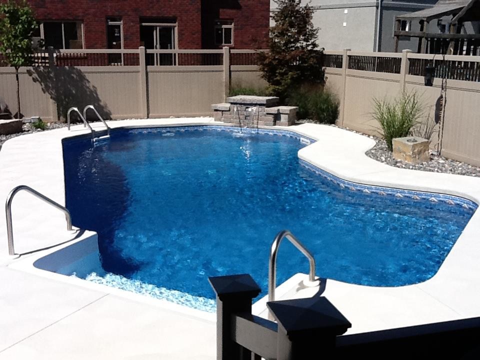 Large backyard stone pool photo in Toronto