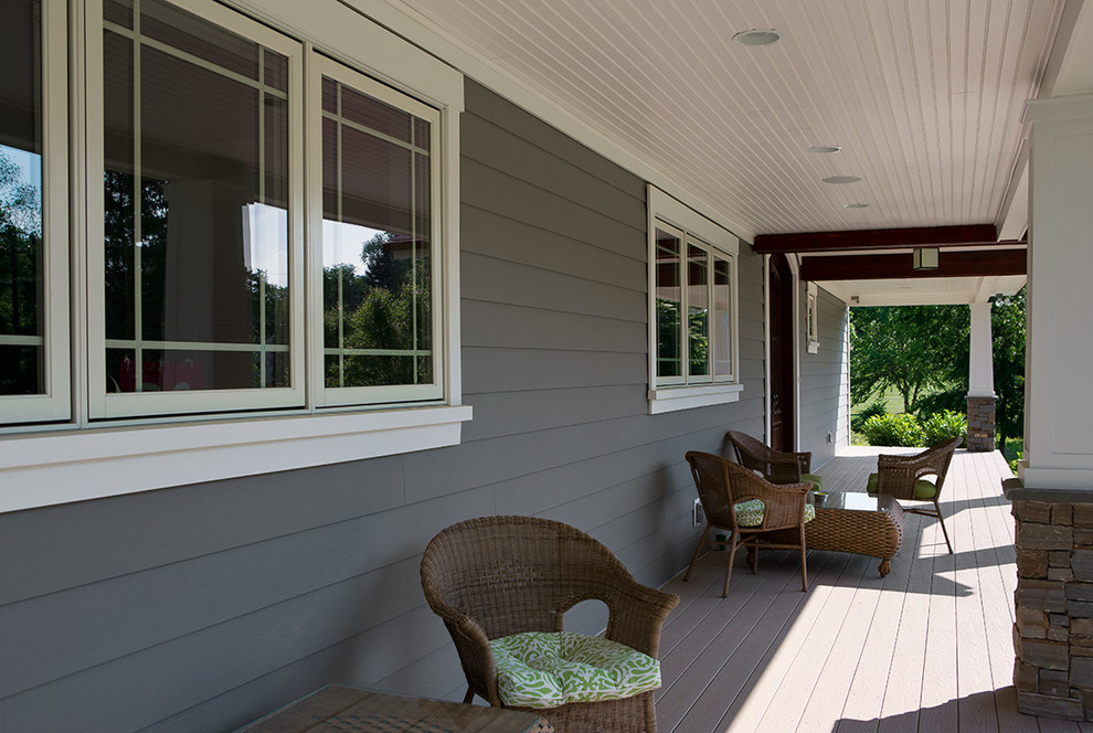 Example of a mid-sized transitional backyard deck design in Orange County with a roof extension
