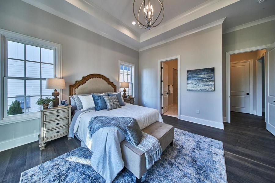 Design ideas for a medium sized traditional master bedroom in Columbus with white walls, medium hardwood flooring and a drop ceiling.
