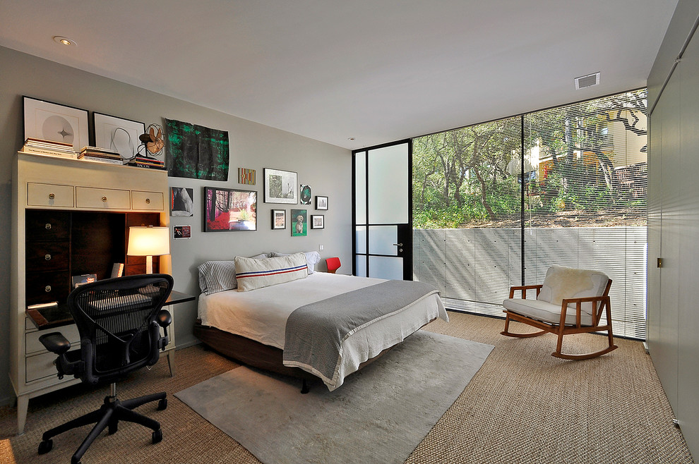 This is an example of a mid-sized contemporary master bedroom in Austin with grey walls and bamboo floors.