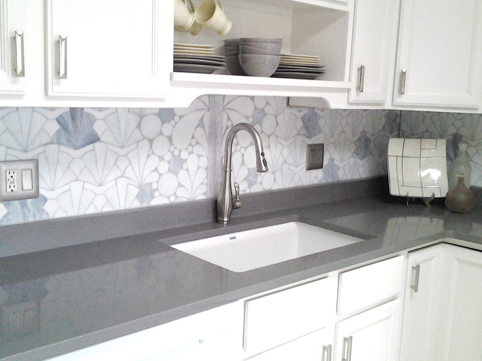 Mid-sized contemporary l-shaped kitchen in New York with glass tile splashback.