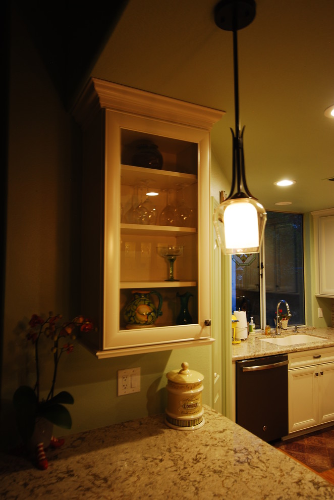 Example of a transitional kitchen design with flat-panel cabinets and white cabinets