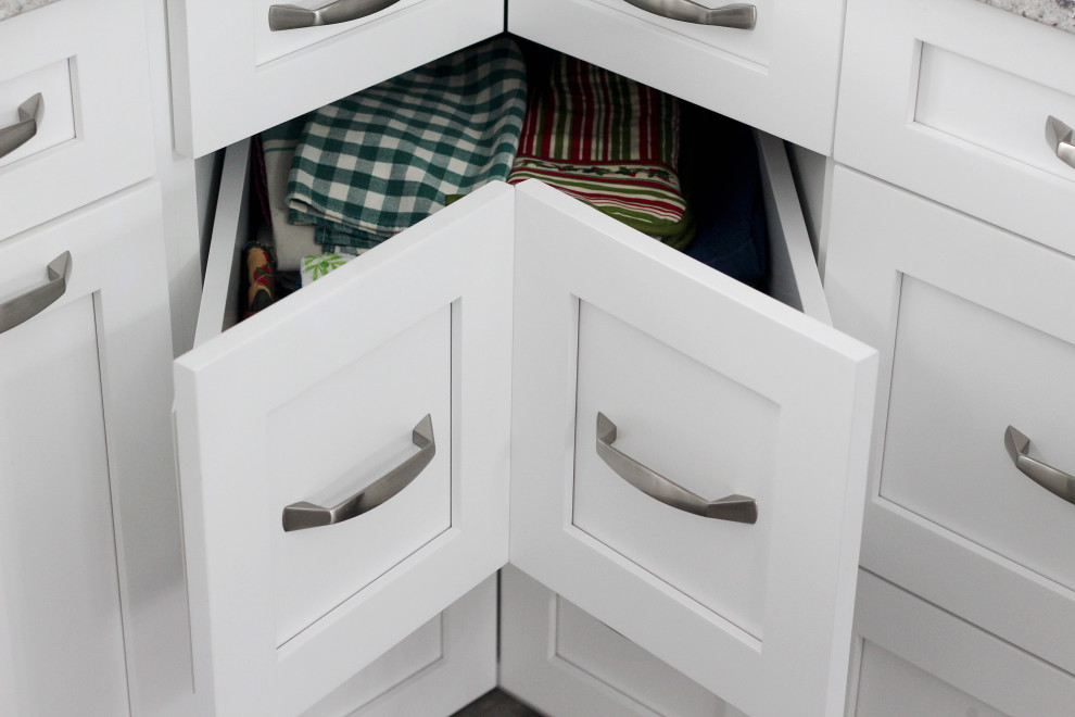 Example of an u-shaped kitchen design with shaker cabinets, white cabinets, quartzite countertops, gray backsplash, subway tile backsplash, a peninsula and gray countertops