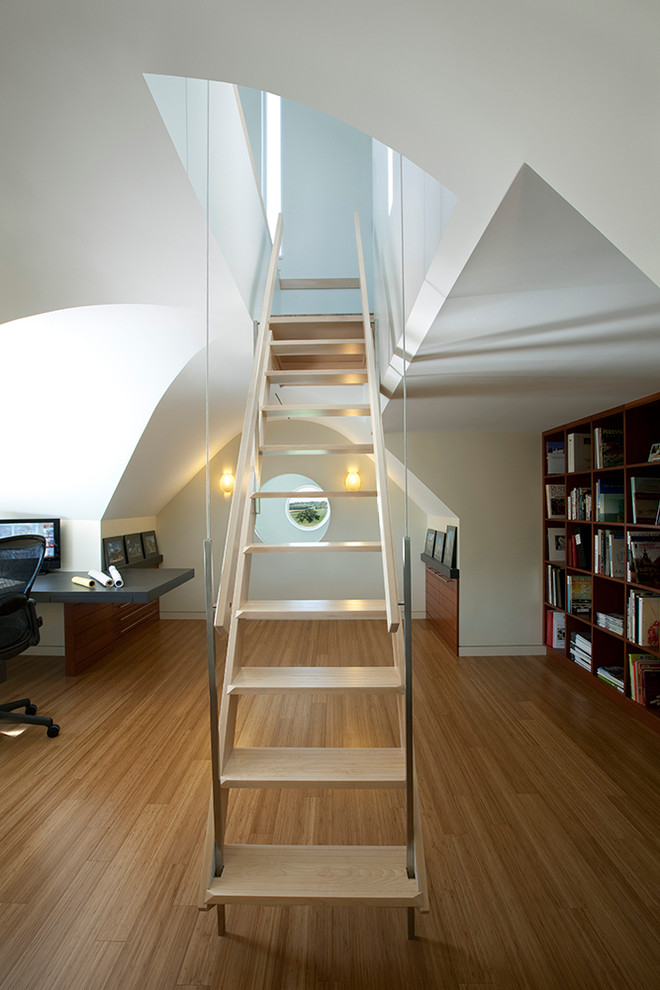 Inspiration for a contemporary wood straight staircase in Cedar Rapids with open risers.