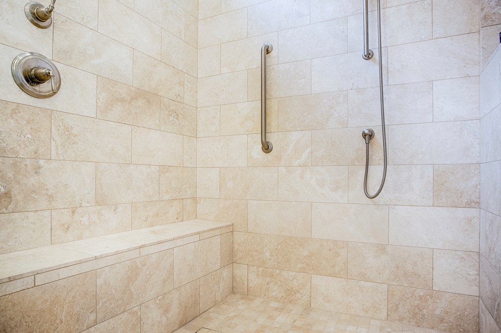 Example of a large transitional master beige tile and travertine tile travertine floor corner shower design in Phoenix with recessed-panel cabinets, white cabinets, green walls, an undermount sink and granite countertops