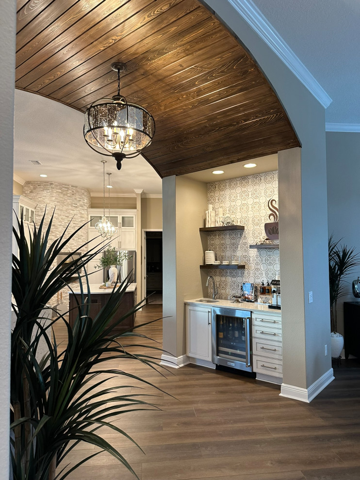 Example of a transitional wood ceiling kitchen design in Orlando with white backsplash