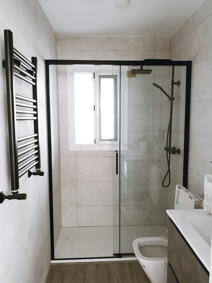 This is an example of a medium sized scandi cloakroom in Madrid with flat-panel cabinets, dark wood cabinets, a wall mounted toilet, beige tiles, cement tiles, beige walls, dark hardwood flooring, an integrated sink, laminate worktops, brown floors, white worktops and a floating vanity unit.