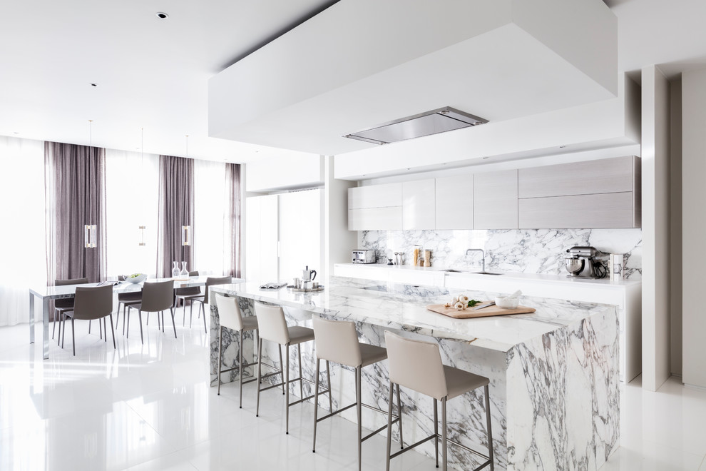 Inspiration for a mid-sized contemporary eat-in kitchen in London with a double-bowl sink, flat-panel cabinets, grey cabinets, marble benchtops, white splashback, marble splashback, ceramic floors, with island, white floor and white benchtop.