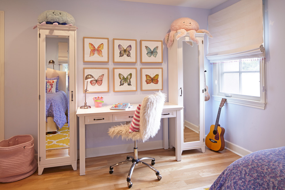 Design ideas for a mid-sized transitional kids' bedroom for girls and kids 4-10 years old in Los Angeles with purple walls and light hardwood floors.