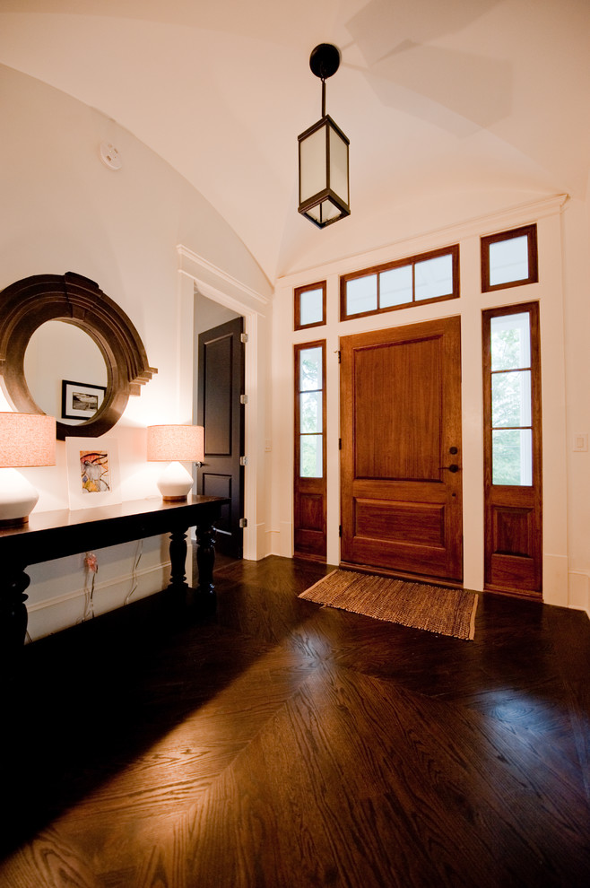 Photo of a mid-sized traditional foyer in Atlanta with a single front door, a dark wood front door, white walls and dark hardwood floors.