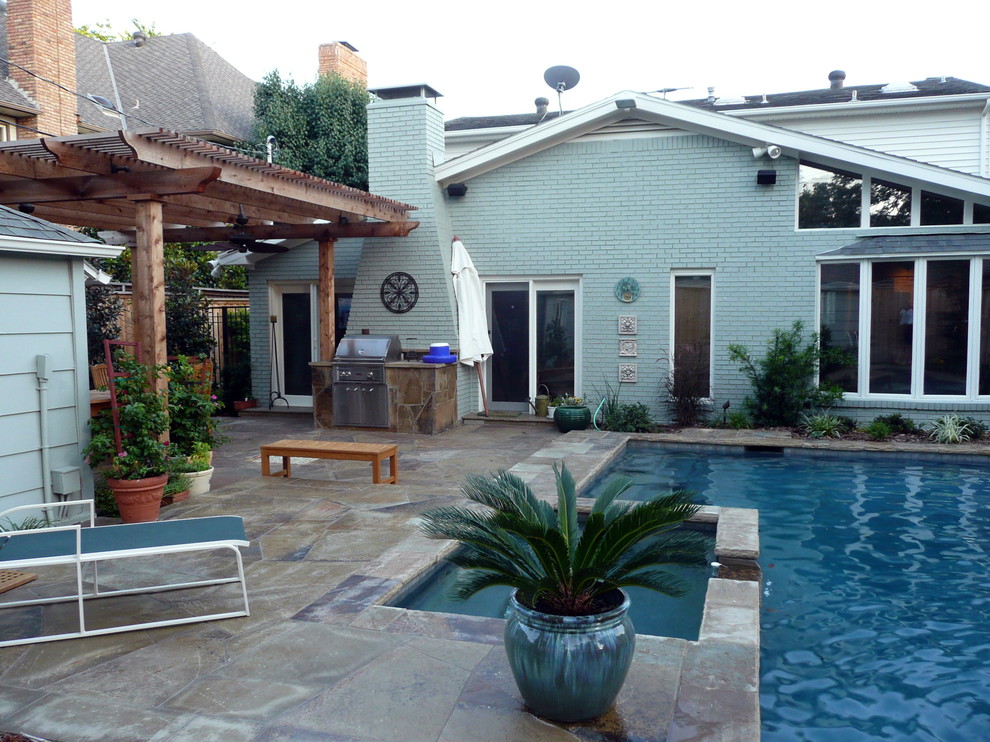 Design ideas for a contemporary backyard patio in Dallas with natural stone pavers and a pergola.