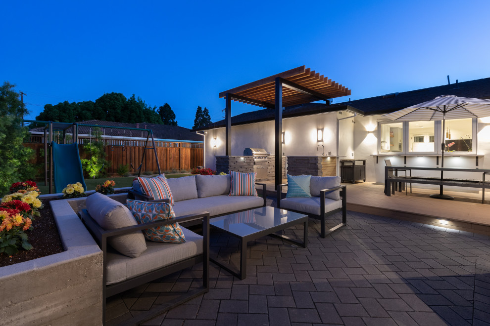 Photo of a mid-sized contemporary backyard patio in San Francisco with an outdoor kitchen, concrete pavers and a pergola.
