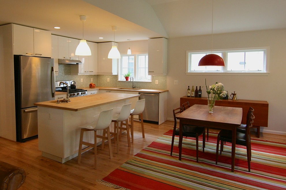 Photo of a small midcentury kitchen/dining combo in DC Metro with white walls and light hardwood floors.