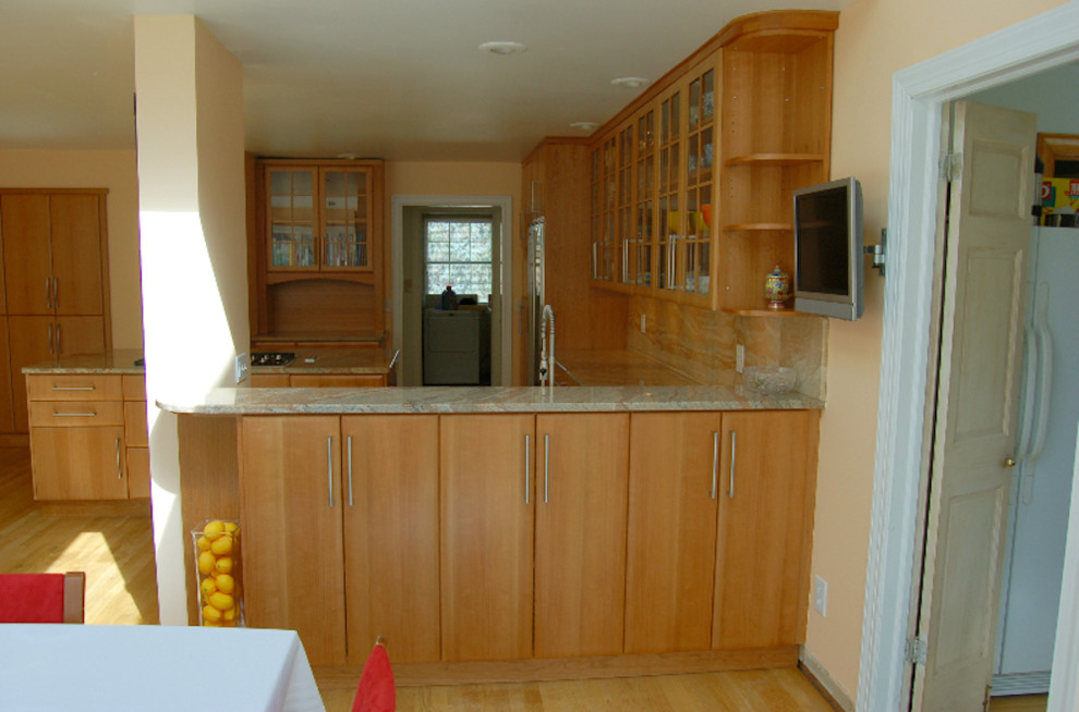 Kitchen - light wood floor kitchen idea with flat-panel cabinets, light wood cabinets and an island