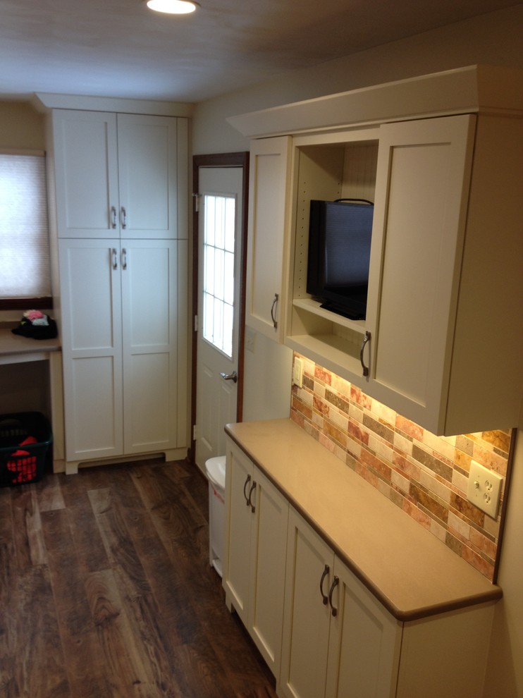Mid-sized transitional l-shaped utility room photo with an undermount sink, shaker cabinets, white cabinets, quartz countertops, beige walls and a side-by-side washer/dryer