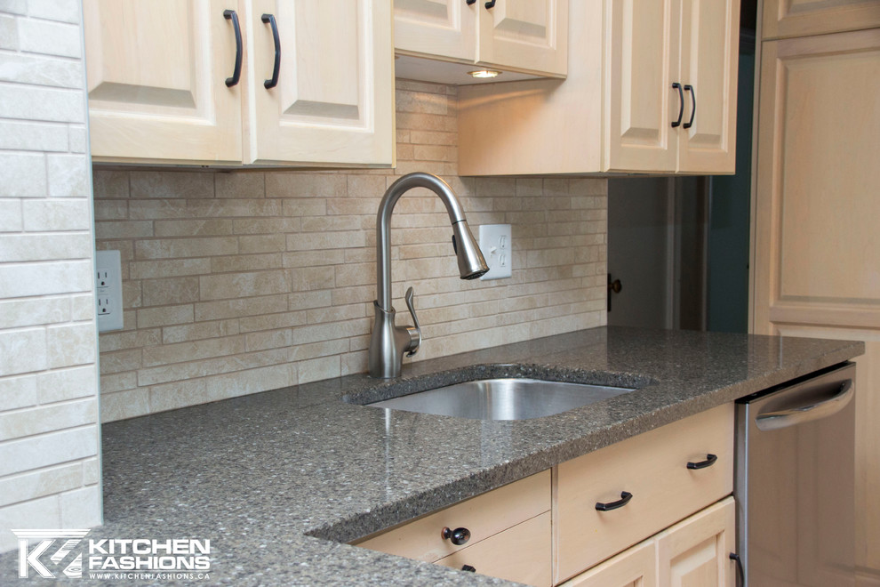 Eat-in kitchen - large contemporary u-shaped porcelain tile eat-in kitchen idea with an undermount sink, raised-panel cabinets, light wood cabinets, quartzite countertops, multicolored backsplash, porcelain backsplash, stainless steel appliances and a peninsula