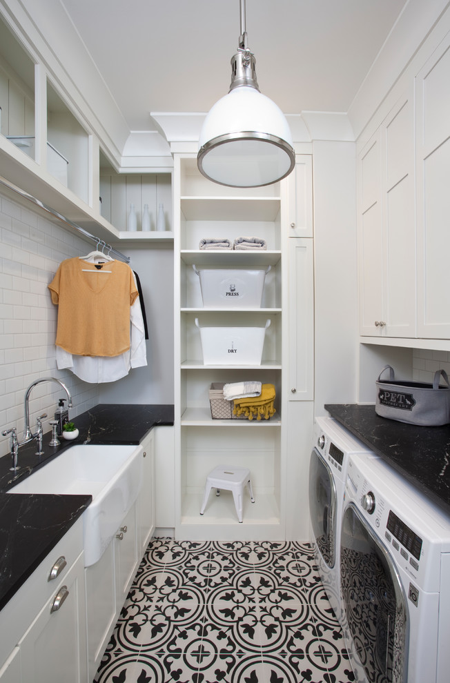 This is an example of a country laundry room in Atlanta with a side-by-side washer and dryer.