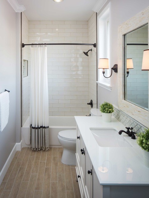 Mid-sized transitional master bathroom in Chicago with recessed-panel cabinets, white cabinets, a drop-in tub, a shower/bathtub combo, a two-piece toilet, white tile, porcelain tile, light hardwood floors, a drop-in sink, soapstone benchtops, beige floor, a shower curtain and grey walls.