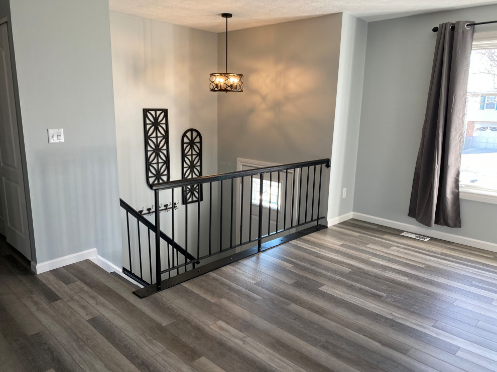 Inspiration for a large transitional l-shaped vinyl floor and gray floor open concept kitchen remodel in Cincinnati with an undermount sink, raised-panel cabinets, white cabinets, granite countertops, multicolored backsplash, ceramic backsplash, stainless steel appliances, an island and black countertops