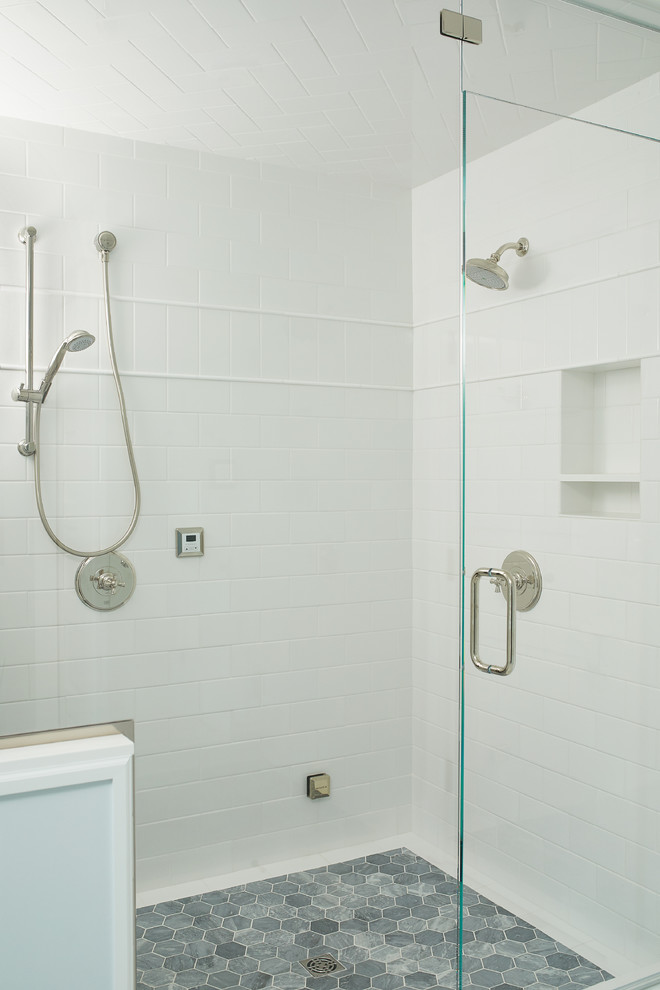 Design ideas for a large beach style master bathroom in Grand Rapids with flat-panel cabinets, white cabinets, an alcove shower, white tile, ceramic tile, white walls, marble floors, an undermount sink, marble benchtops, multi-coloured floor, a hinged shower door and blue benchtops.