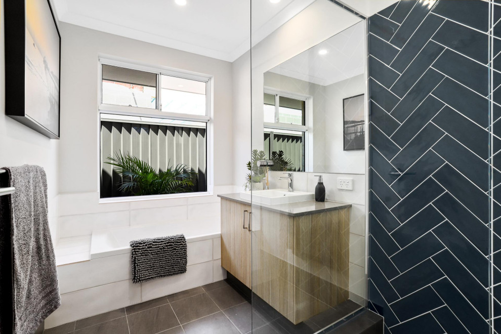 Photo of a mid-sized contemporary master bathroom in Perth with flat-panel cabinets, medium wood cabinets, a corner shower, black tile, porcelain tile, grey walls, porcelain floors, a vessel sink, grey floor, grey benchtops, a single vanity and a built-in vanity.