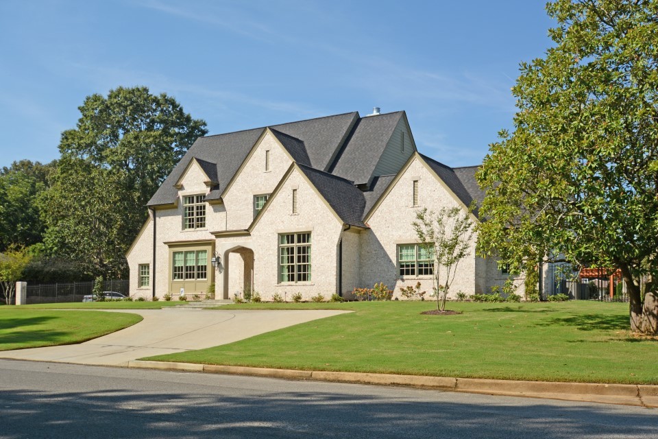 Inspiration for a large traditional two-storey brick beige exterior in Other with a gable roof.