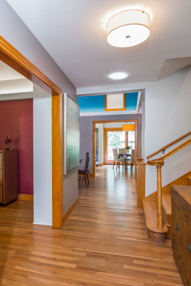 Mid-sized transitional medium tone wood floor front door photo in Austin with white walls