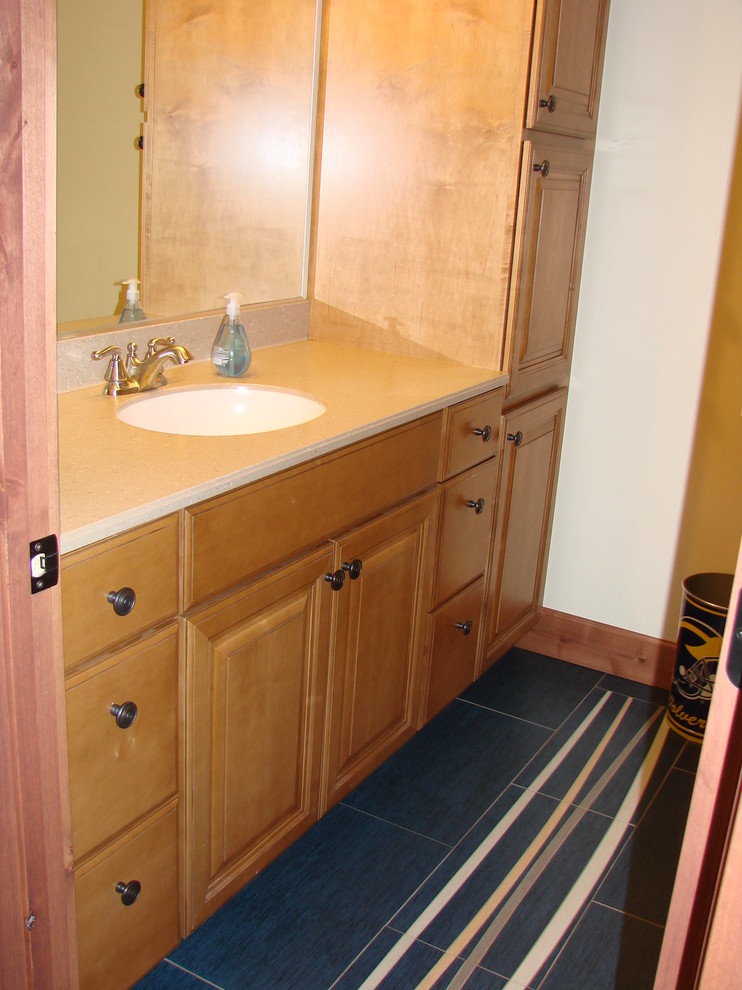This is an example of a mid-sized country 3/4 bathroom in Minneapolis with raised-panel cabinets, light wood cabinets, white walls, porcelain floors, an undermount sink, engineered quartz benchtops, multi-coloured floor and beige benchtops.