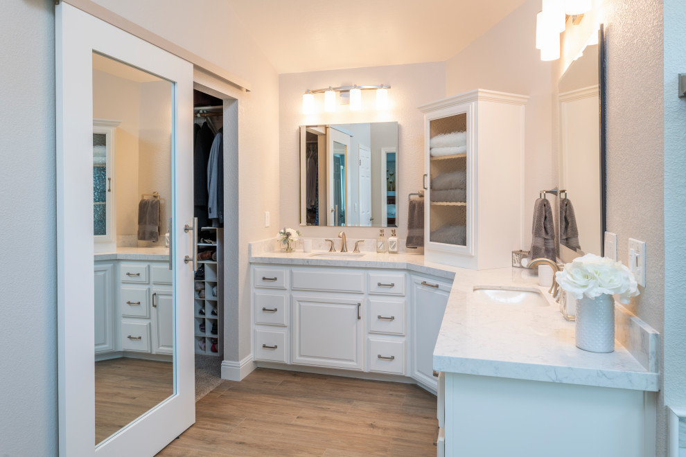 Contemporary master bathroom in San Francisco with white cabinets, a freestanding tub, a corner shower, gray tile, marble, beige walls, porcelain floors, an undermount sink, engineered quartz benchtops, brown floor, a hinged shower door, white benchtops, a double vanity and a built-in vanity.