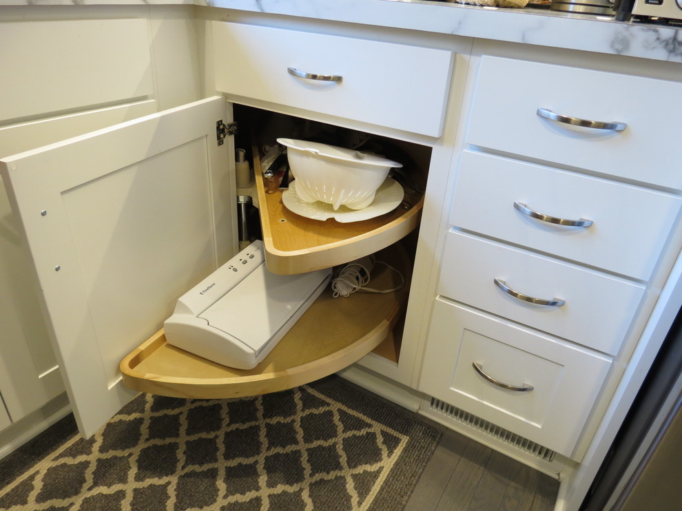 Inspiration for a mid-sized transitional u-shaped light wood floor and brown floor kitchen remodel with shaker cabinets, white cabinets, marble countertops and no island