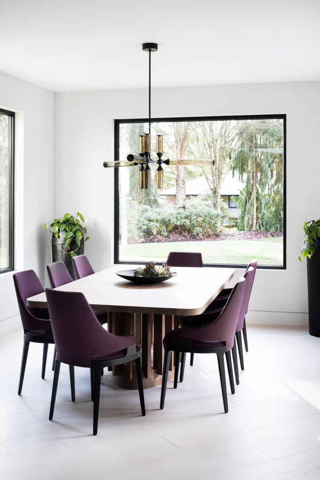 This is an example of an expansive modern dining room in Vancouver with white walls and light hardwood floors.