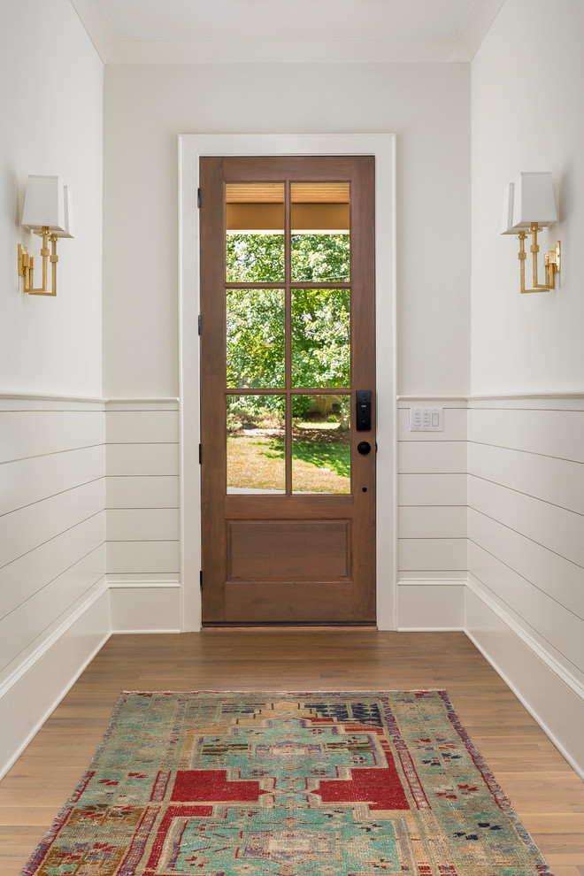 Inspiration for a mid-sized transitional medium tone wood floor foyer remodel in Charlotte with beige walls and a medium wood front door
