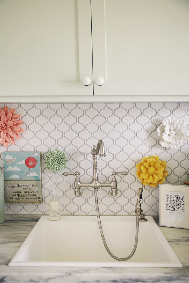 Inspiration for a mid-sized rustic galley white floor dedicated laundry room remodel with a single-bowl sink, shaker cabinets, beige cabinets, green walls, a side-by-side washer/dryer and gray countertops