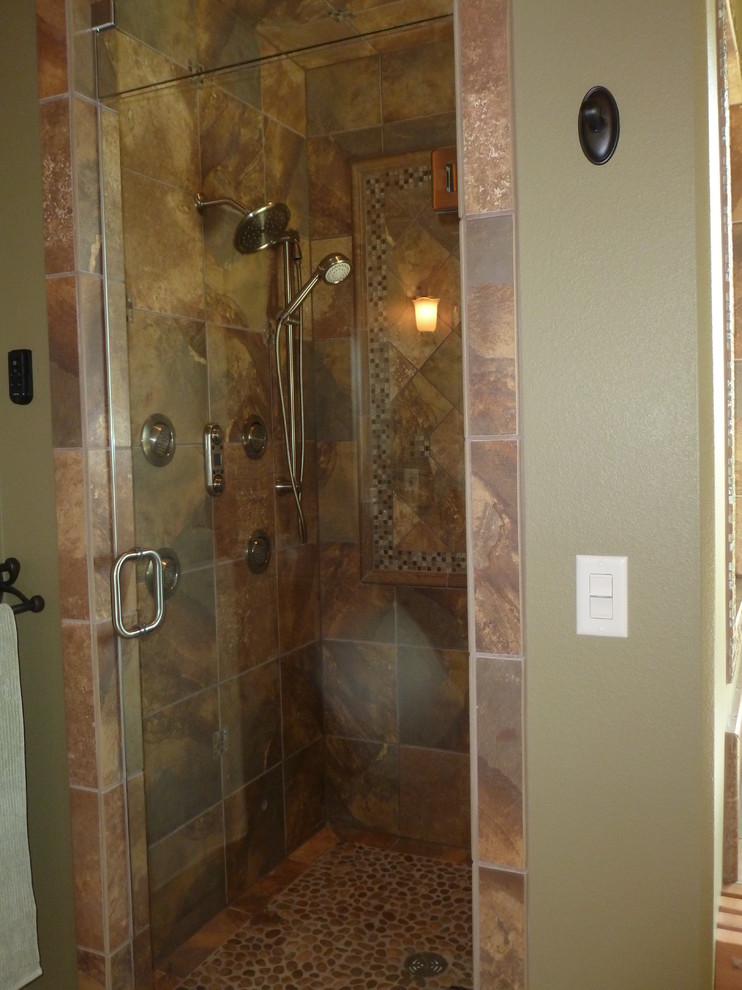 Traditional master bathroom in Other with raised-panel cabinets, dark wood cabinets, a drop-in tub, an alcove shower, multi-coloured tile, porcelain tile, green walls, porcelain floors, an undermount sink and granite benchtops.
