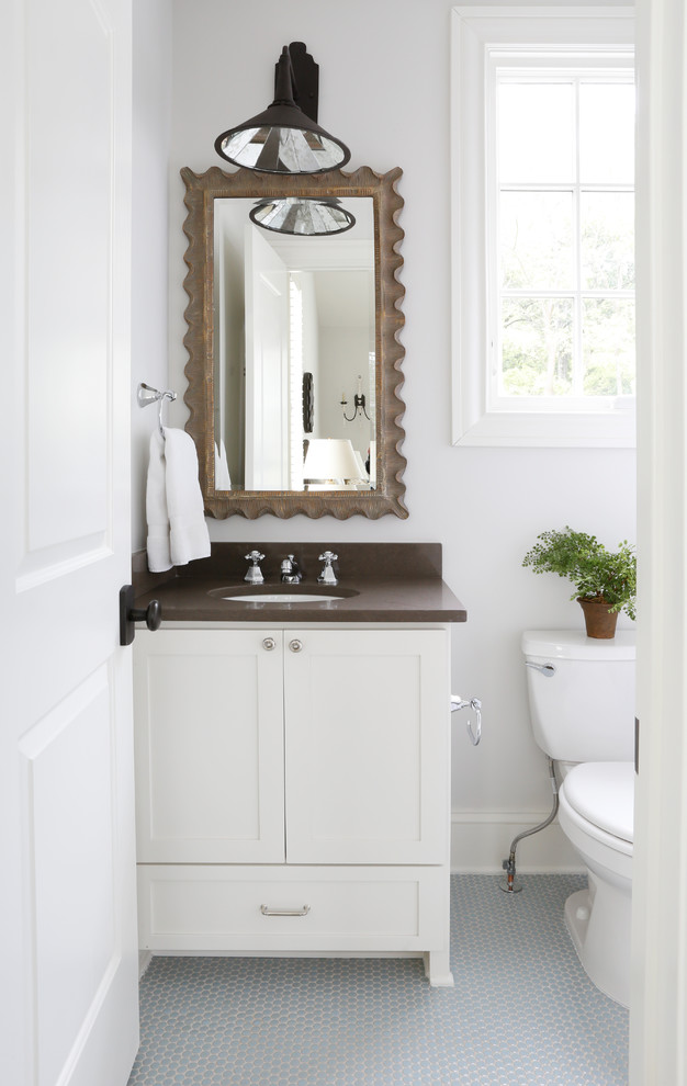 Inspiration for a transitional powder room in Nashville with shaker cabinets, white cabinets, a two-piece toilet, white walls, mosaic tile floors, an undermount sink, blue floor and brown benchtops.