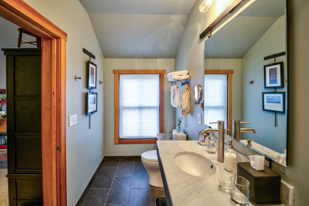 Mid-sized industrial bathroom with a double shower, a one-piece toilet, white tile, porcelain tile, green walls, porcelain floors, an undermount sink, marble benchtops, grey floor and a shower curtain.